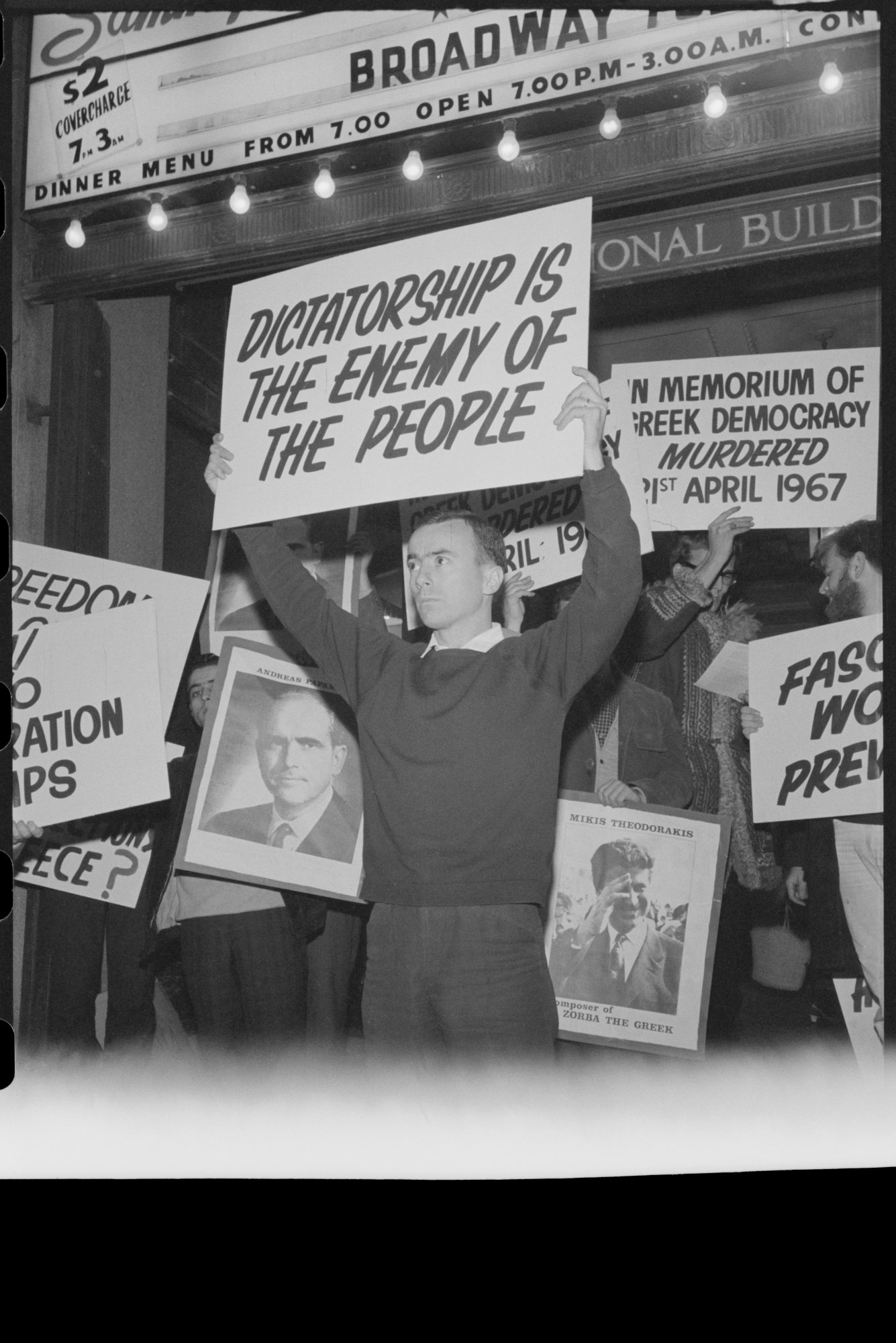 Simon Townsend holding a protest sign reading Dictatorship Is The Enemy Of The People, 1967
