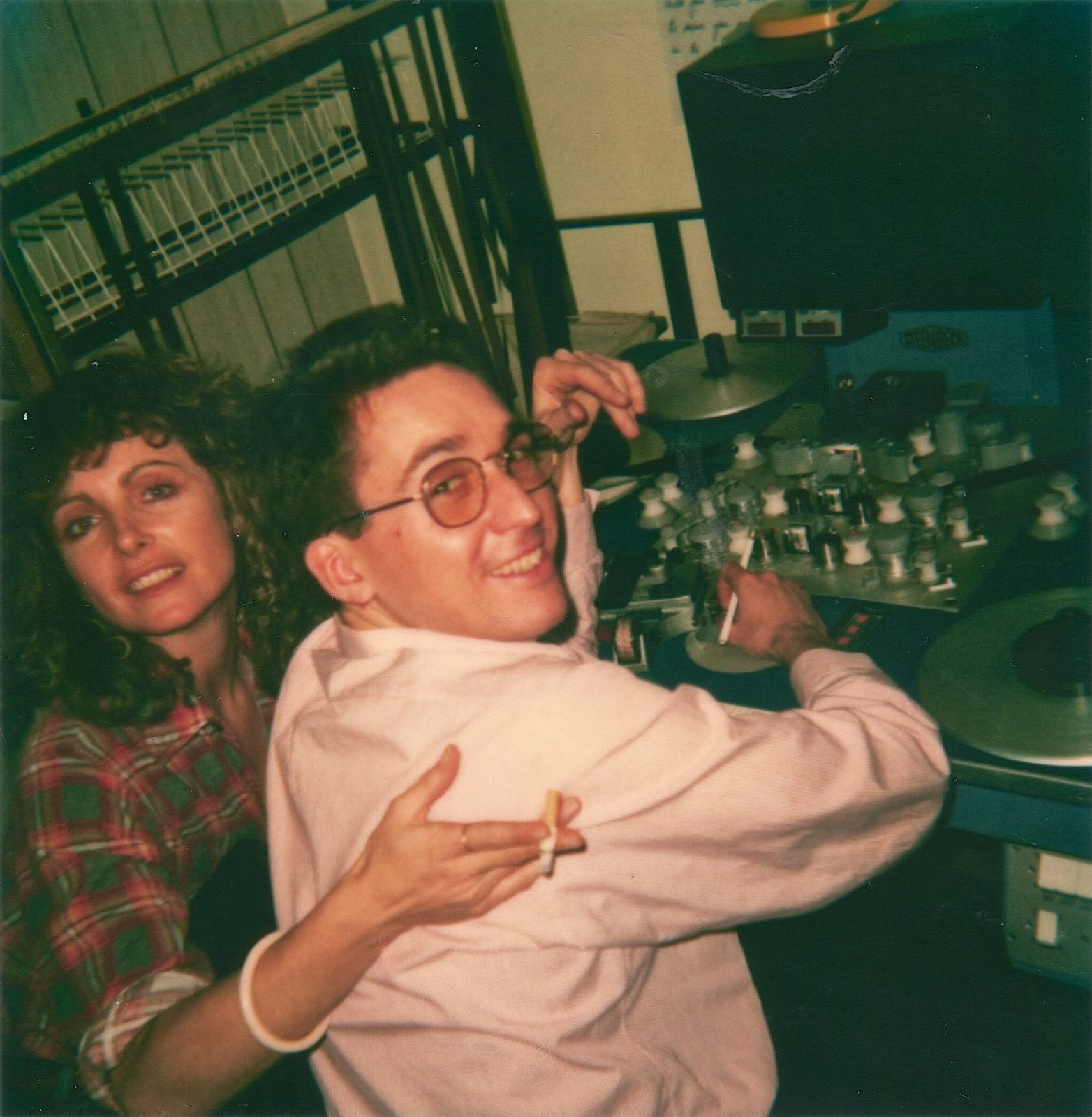Two Wonder World crew members laughing in the tape and edit room, surrounded by reel-to-reel decks